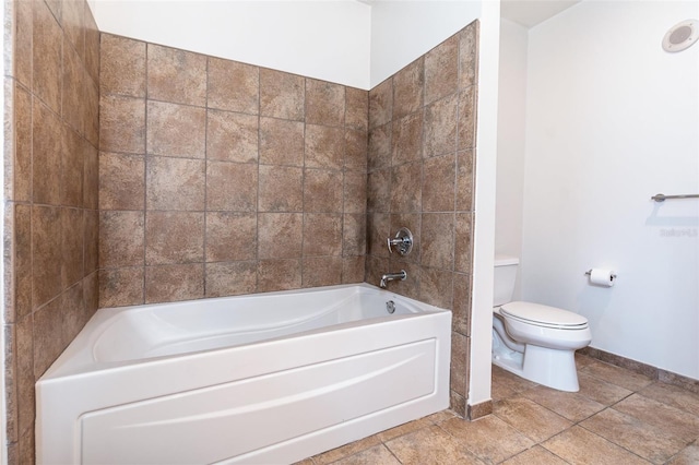 bathroom featuring toilet and tile patterned flooring