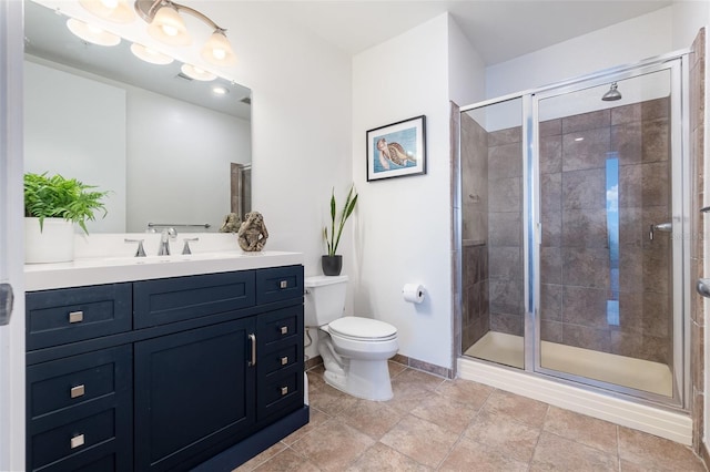 bathroom featuring toilet, a shower with shower door, and vanity