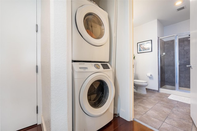 laundry area featuring stacked washer and clothes dryer