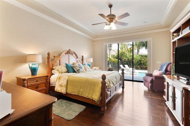 bedroom featuring ceiling fan, access to exterior, dark hardwood / wood-style floors, crown molding, and a tray ceiling