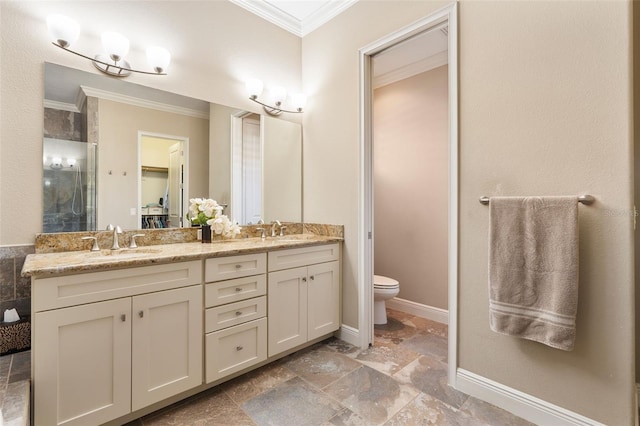 bathroom featuring toilet, crown molding, and vanity