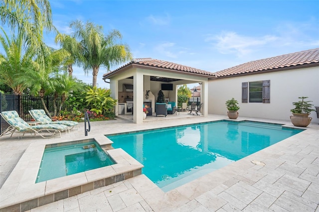 view of swimming pool with a patio, a gazebo, an in ground hot tub, and an outdoor bar