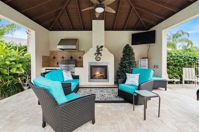 view of patio with an outdoor kitchen, a gazebo, exterior fireplace, and area for grilling