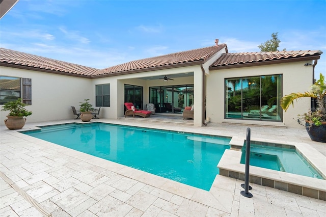 back of house featuring a pool with hot tub, ceiling fan, and a patio area