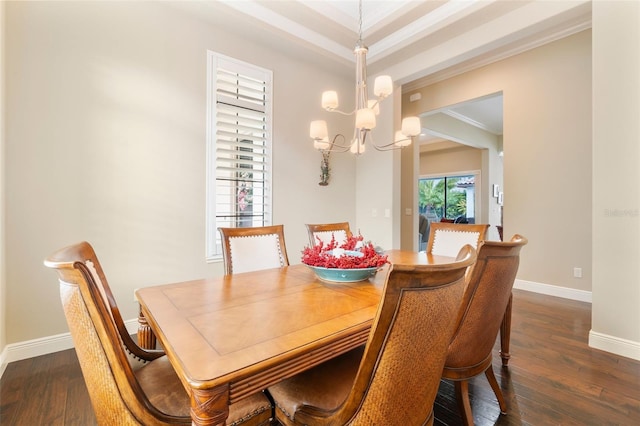 dining room with ornamental molding, dark hardwood / wood-style floors, and a notable chandelier