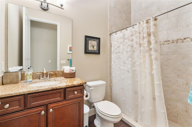 bathroom featuring curtained shower, wood-type flooring, toilet, and vanity