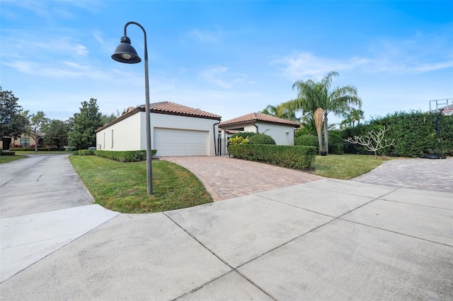 view of front of property featuring a garage and a front lawn