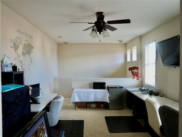 bedroom featuring ceiling fan, stainless steel fridge, and light colored carpet