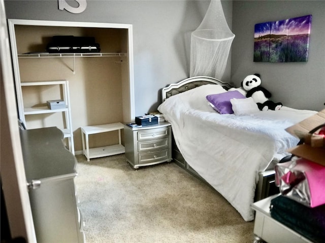 bedroom featuring light carpet and a closet