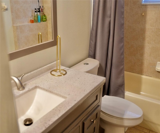 full bathroom with shower / bath combo, vanity, tile patterned floors, and toilet