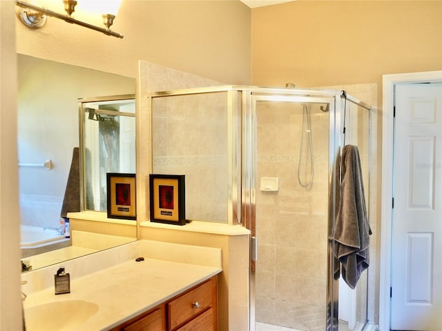 bathroom with vanity and a shower with shower door