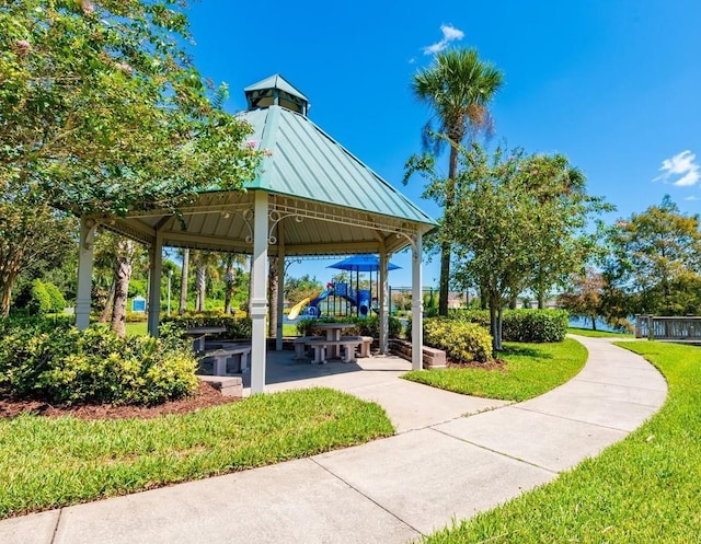 view of home's community with a playground and a lawn