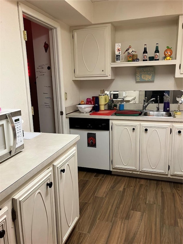 kitchen featuring sink, white cabinetry, dark hardwood / wood-style floors, and dishwasher