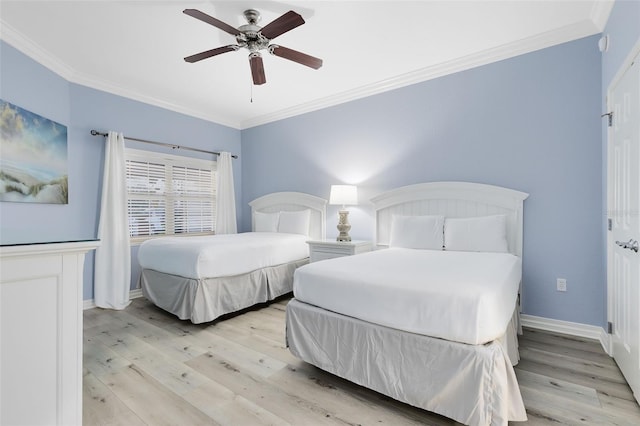 bedroom with ornamental molding, ceiling fan, and light wood-type flooring