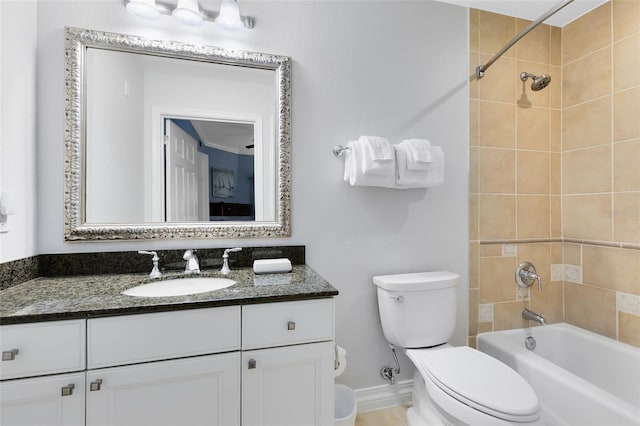 full bathroom featuring vanity, tiled shower / bath, and toilet