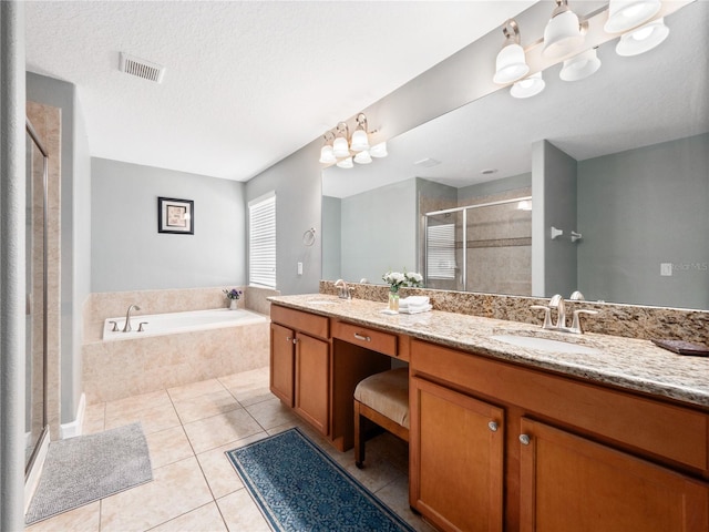 bathroom featuring a notable chandelier, tile patterned flooring, a textured ceiling, shower with separate bathtub, and vanity