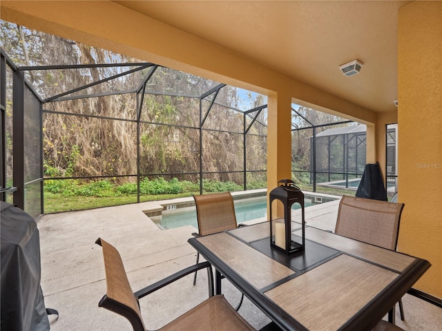 view of patio / terrace with glass enclosure and a grill