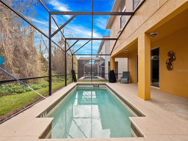 view of swimming pool with a hot tub, a patio area, and glass enclosure