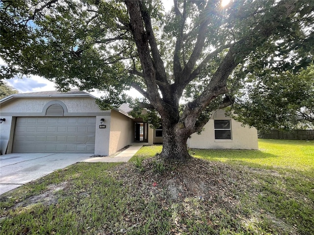 view of front of house with a garage and a front lawn