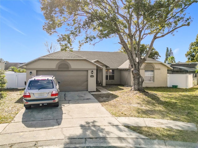 ranch-style house featuring a garage and a front lawn