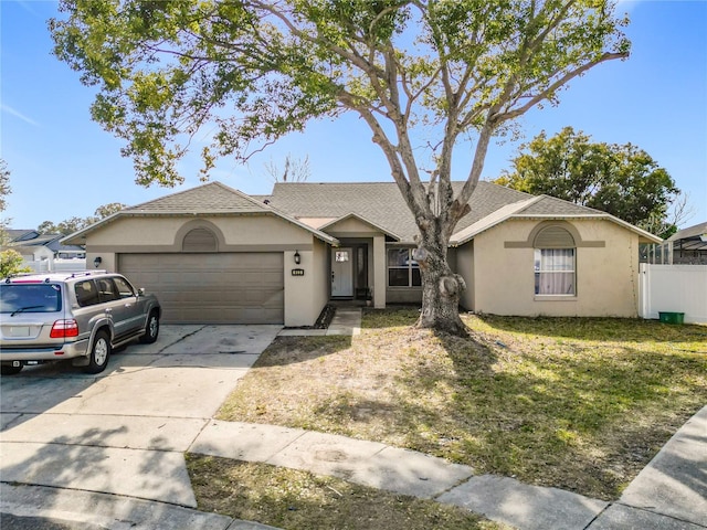 ranch-style house featuring a garage and a front lawn