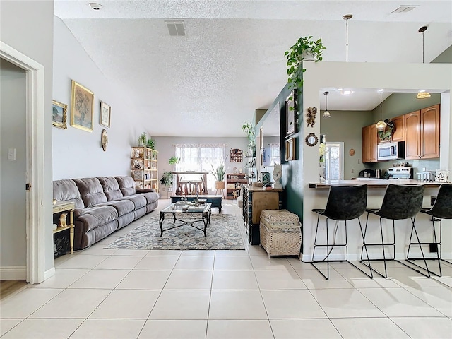 living room with light tile patterned floors and a textured ceiling