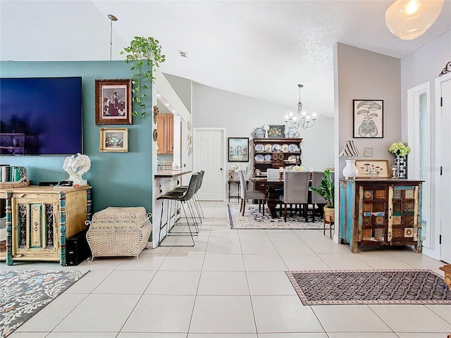 interior space with light tile patterned floors, vaulted ceiling, and a chandelier