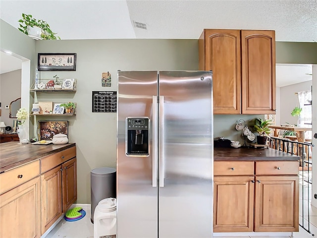 kitchen featuring stainless steel refrigerator with ice dispenser