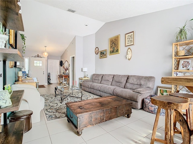 tiled living room featuring vaulted ceiling