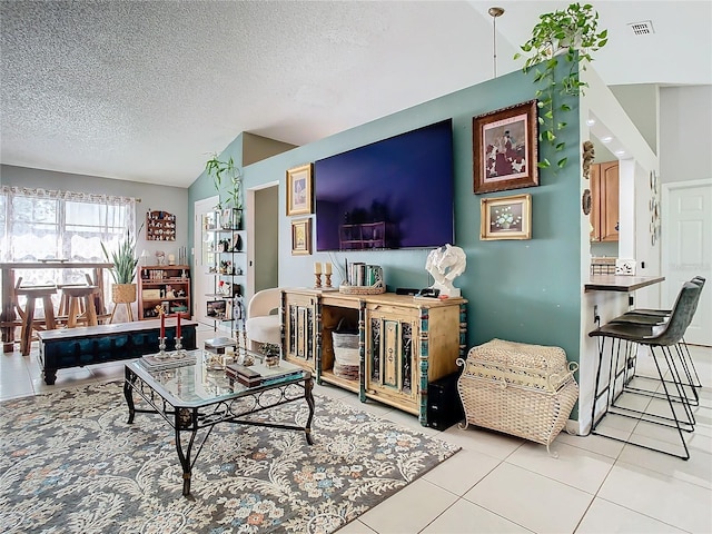 tiled living room with lofted ceiling and a textured ceiling