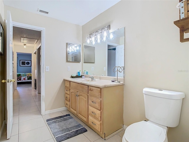 bathroom with vanity, tile patterned floors, and toilet