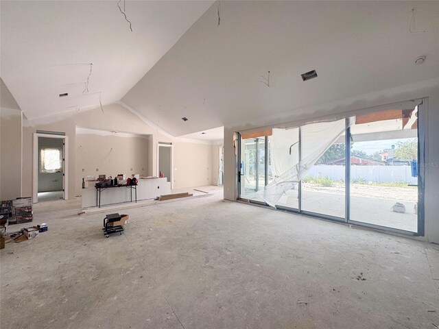 unfurnished living room featuring lofted ceiling