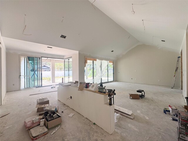 unfurnished living room featuring lofted ceiling and visible vents