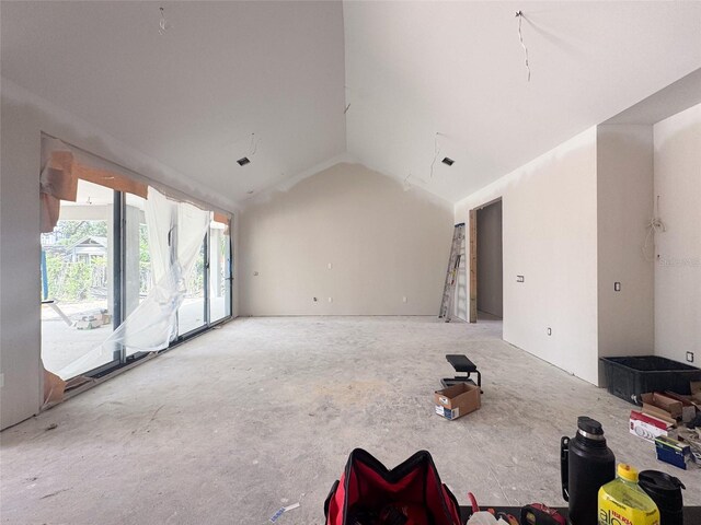 unfurnished living room featuring lofted ceiling