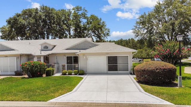 single story home featuring a garage and a front yard