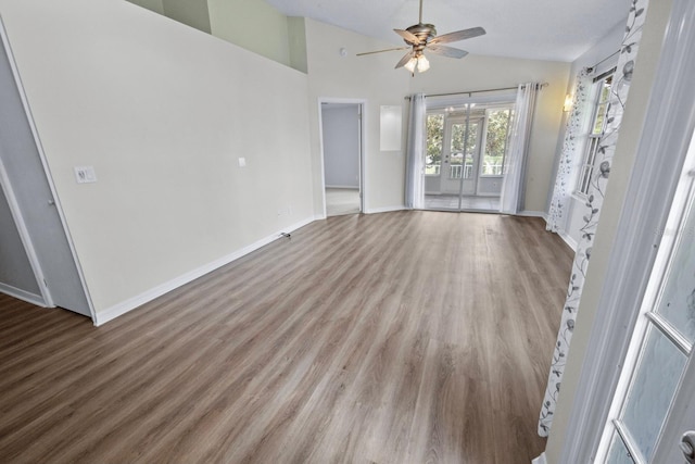 unfurnished living room featuring ceiling fan, light hardwood / wood-style floors, and vaulted ceiling