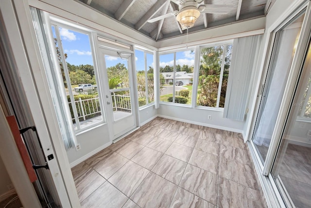 unfurnished sunroom featuring ceiling fan