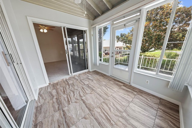 unfurnished sunroom with vaulted ceiling with beams and ceiling fan