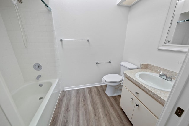 full bathroom featuring vanity, tiled shower / bath combo, wood-type flooring, and toilet