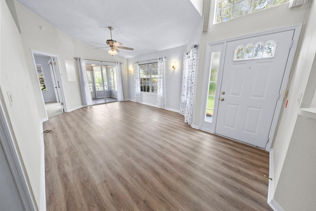 entryway with lofted ceiling, hardwood / wood-style floors, a textured ceiling, and ceiling fan