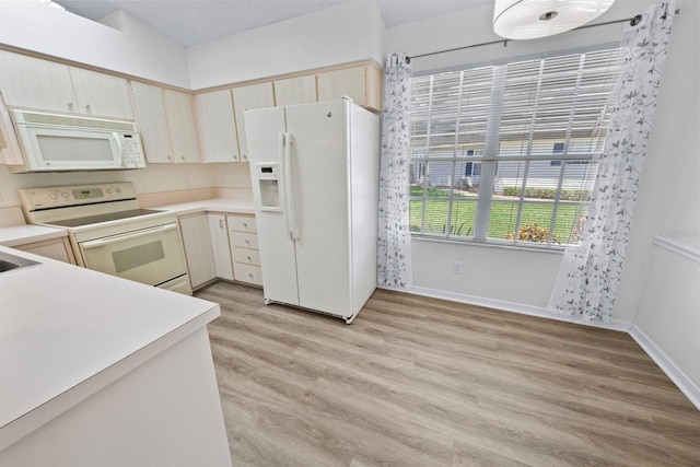 kitchen with white appliances and light wood-type flooring