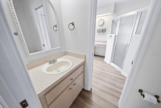 bathroom featuring hardwood / wood-style flooring and vanity