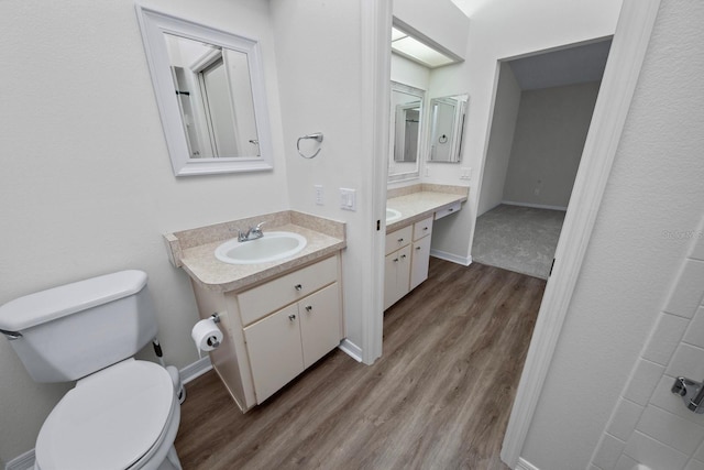 bathroom with vanity, hardwood / wood-style floors, and toilet