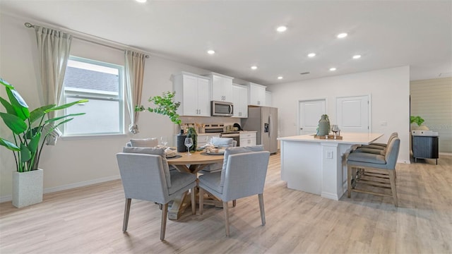 dining space with light hardwood / wood-style floors