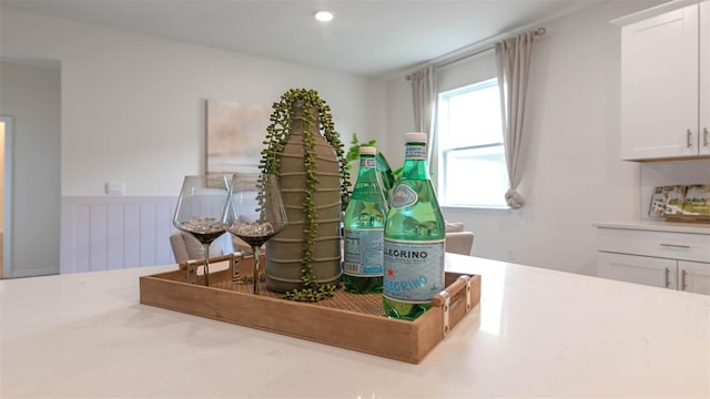 interior space featuring decorative backsplash and white cabinets