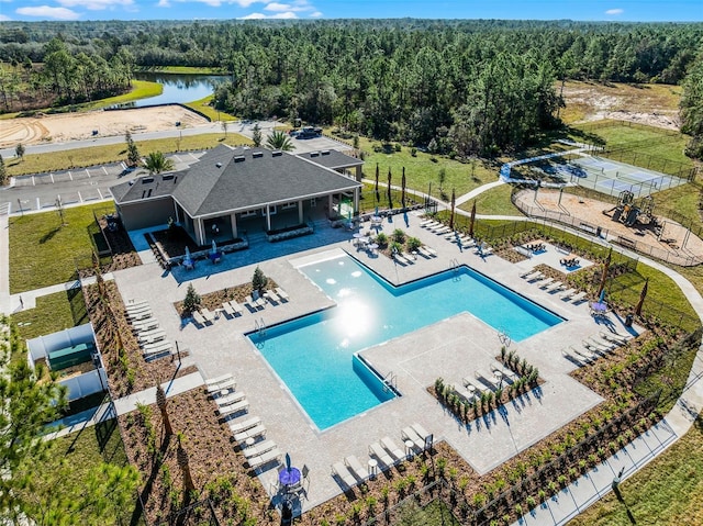 view of pool with a patio and a water view