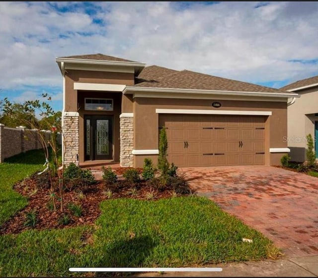 prairie-style home featuring a garage