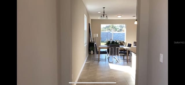 hall featuring light tile patterned floors