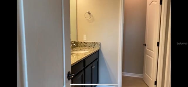 bathroom with tile patterned floors and vanity