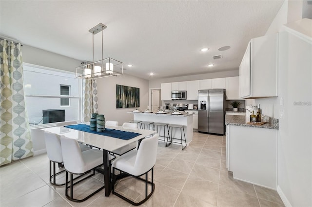 dining area with light tile patterned flooring